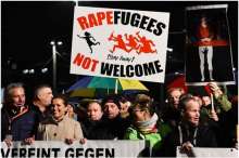 People protesting with signs saying "Rapefugees Not Welcome"
