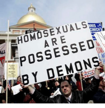 Man with sign "Homosexuals are possessed by demons"