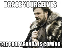 It's a picture of the popular character Ned Stark from Game of Throne dressed for the approaching storm. Instead of saying Winter is Coming, the text says Brace Yourself: The Propaganda is Coming